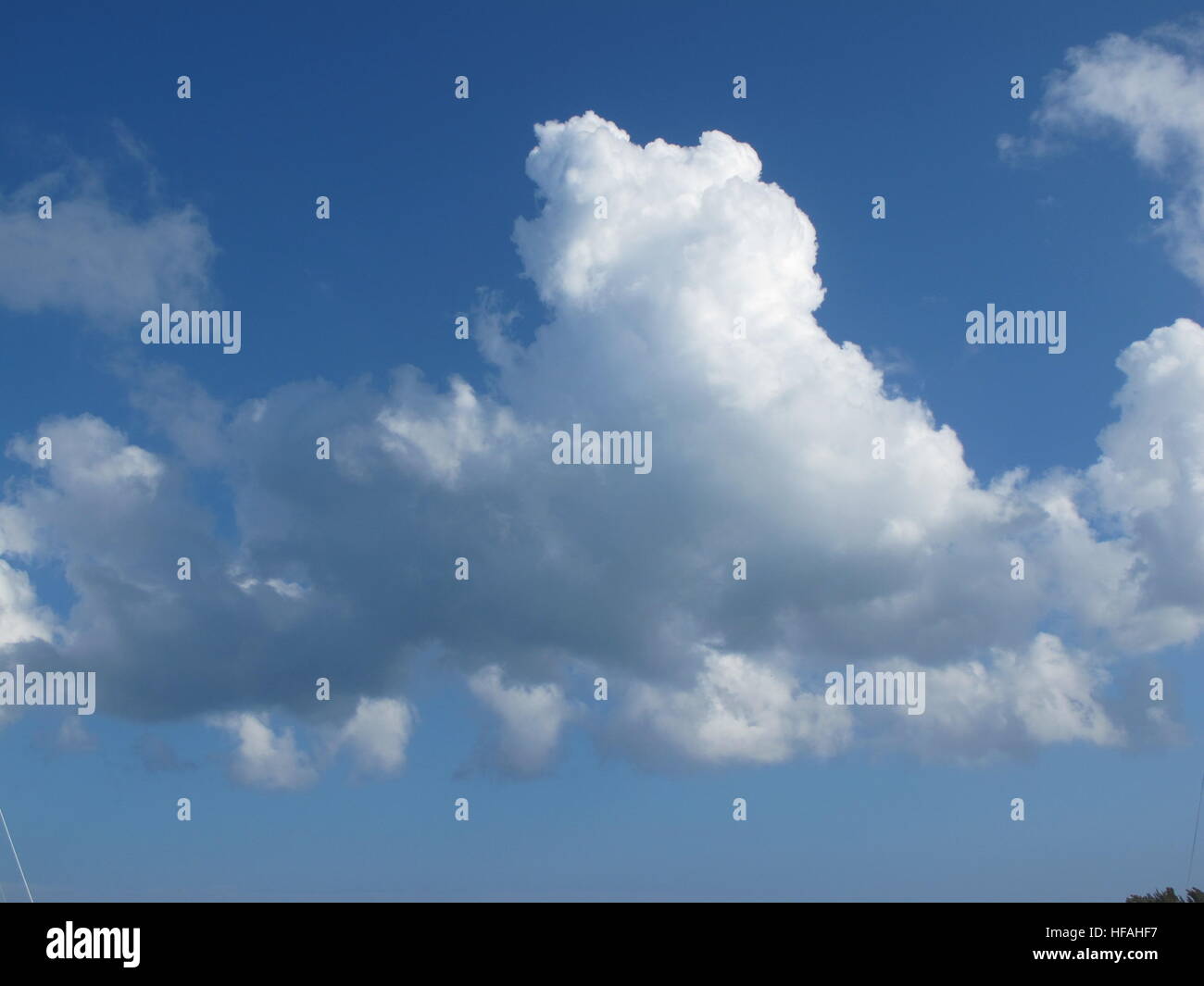 White Clouds in a Blue Sunny Sky Stock Photo - Alamy
