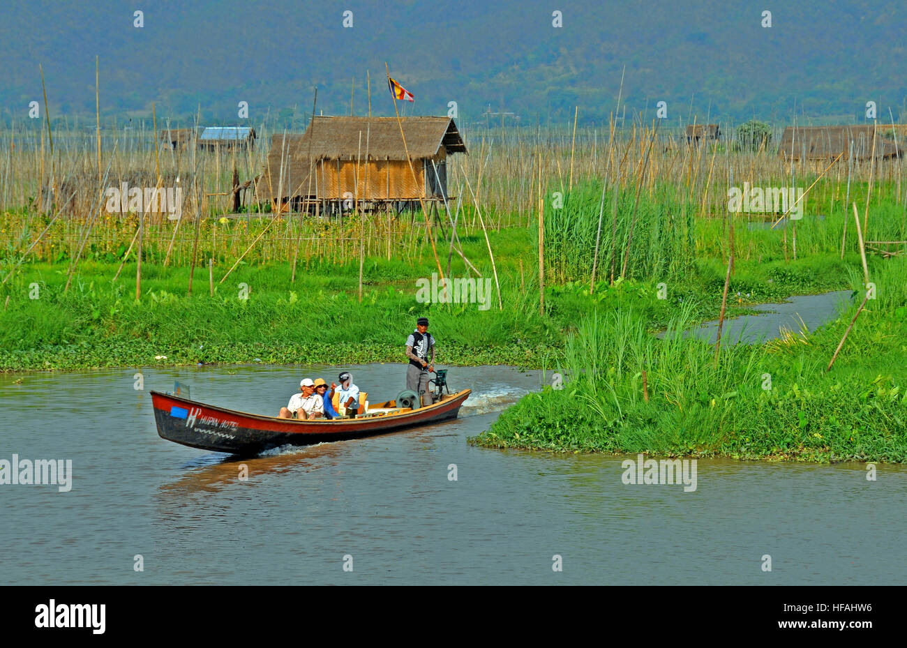 tourists in boat floating garden Inle lake Myanmar Stock Photo
