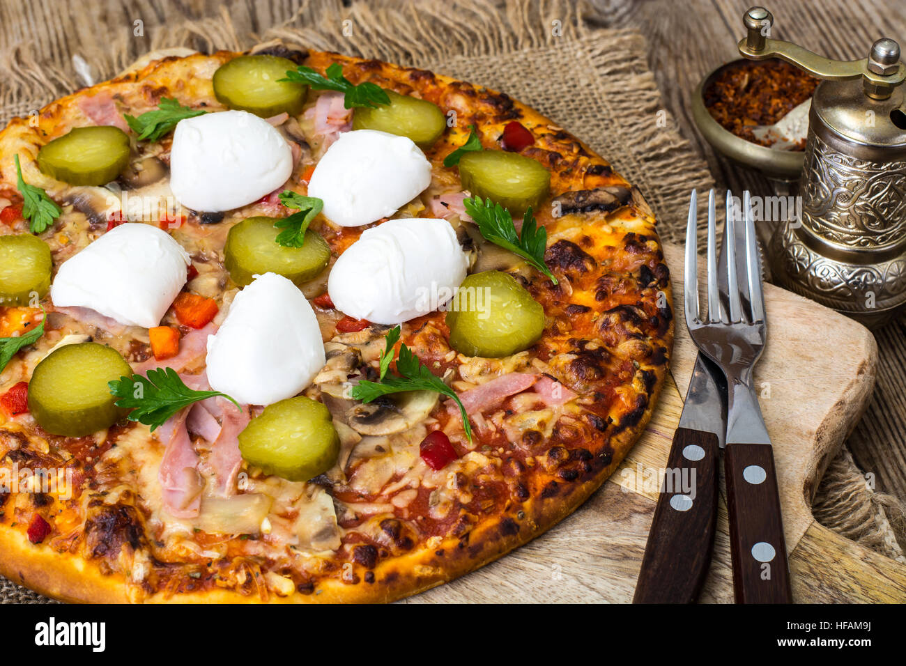 Pizza with ham, mushrooms, gherkin and mozzarella Stock Photo Alamy