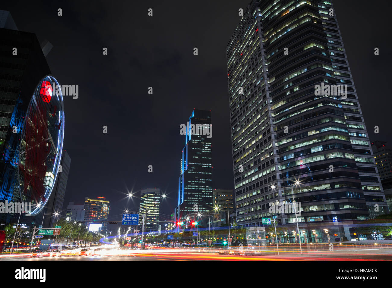 View of light trails and modern skyscrapers in the Gangnam District in Seoul, South Korea at night. Stock Photo