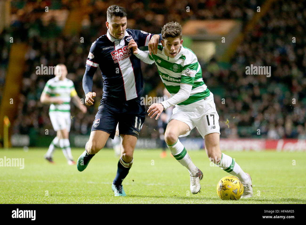 Celtic's Ryan Christie and Ross County's Tim Chow battle for the ball during the Ladbrokes Scottish Premiership match at Celtic Park, Glasgow. Stock Photo