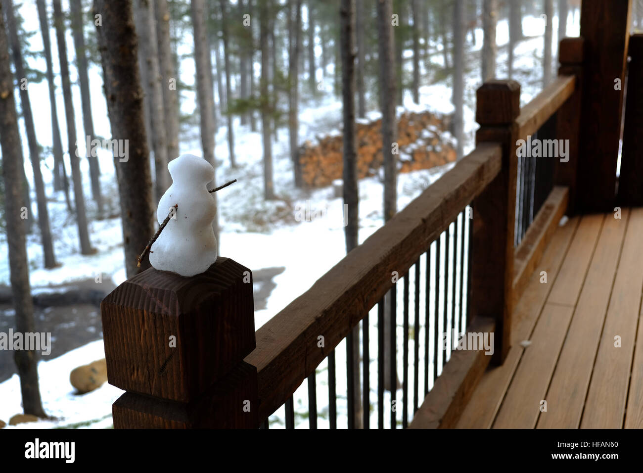 Cabin Railing With Small Snowman In The Forest Rustic Stock Photo