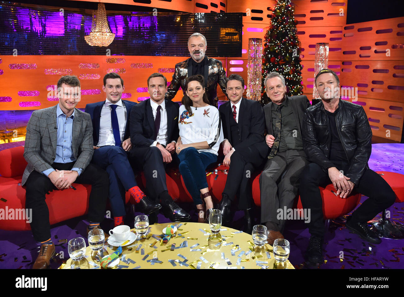 Host Graham Norton (back row) with (left to right front row ) Gary O'Donovan, Paul O'Donovan, Michael Fassbender, Marion Cotillard, James McAvoy, Frank Skinner and Pete Tong during filming of the Graham Norton Show at The London Studios, south London, to be aired on BBC One on New Year's Eve. Stock Photo