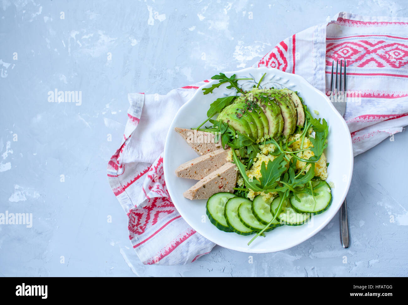 Green salad with avocado, couscous and tofu. Love for a healthy raw food concept. Stock Photo