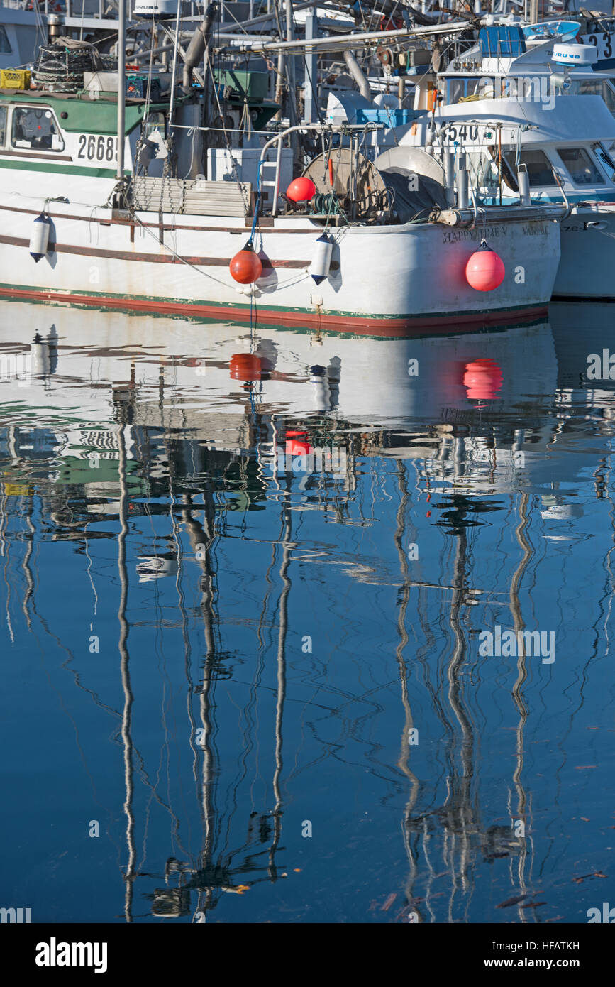Fishing boat water reflections at French Creek harbour on Vancouver