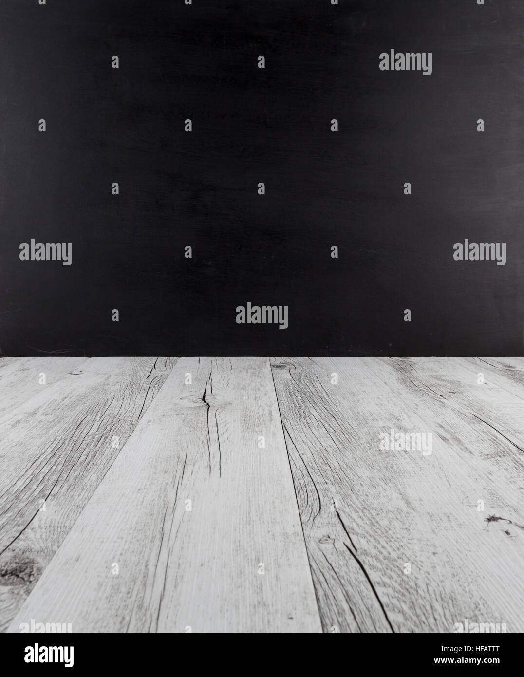 White rustic wooden table with black background and copy space Stock