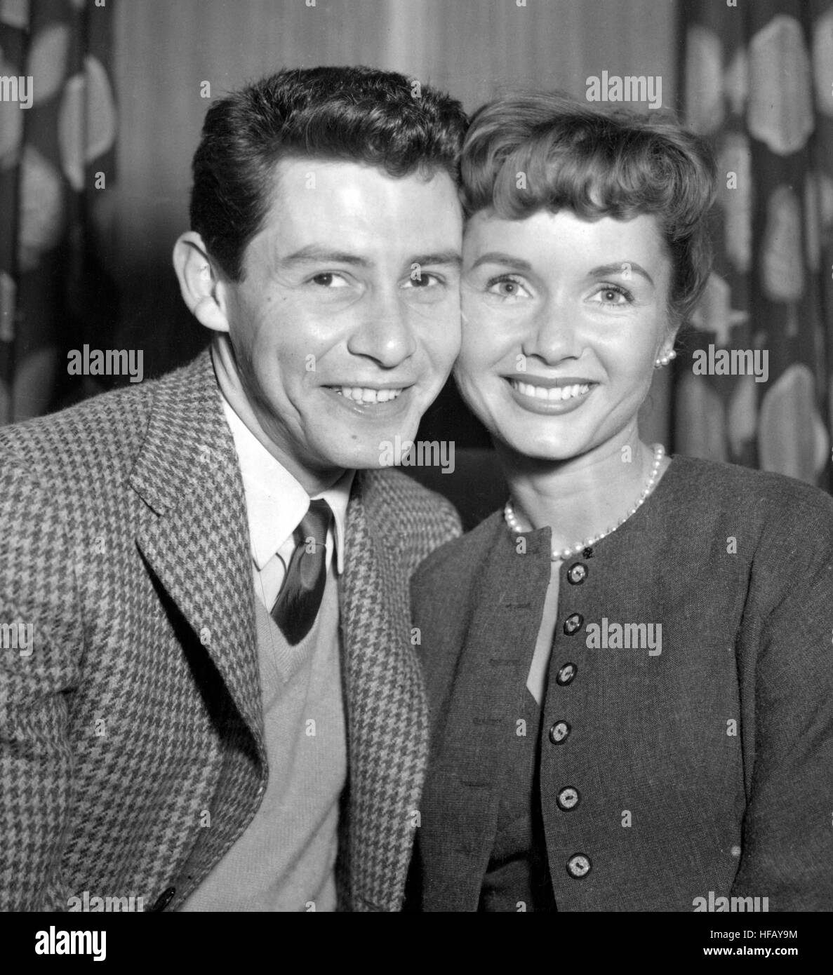 American singer Eddie Fisher and his bride-to-be Debbie Reynolds, newly arrived in London from New York. *Neg corrupt. Scanned from print Stock Photo