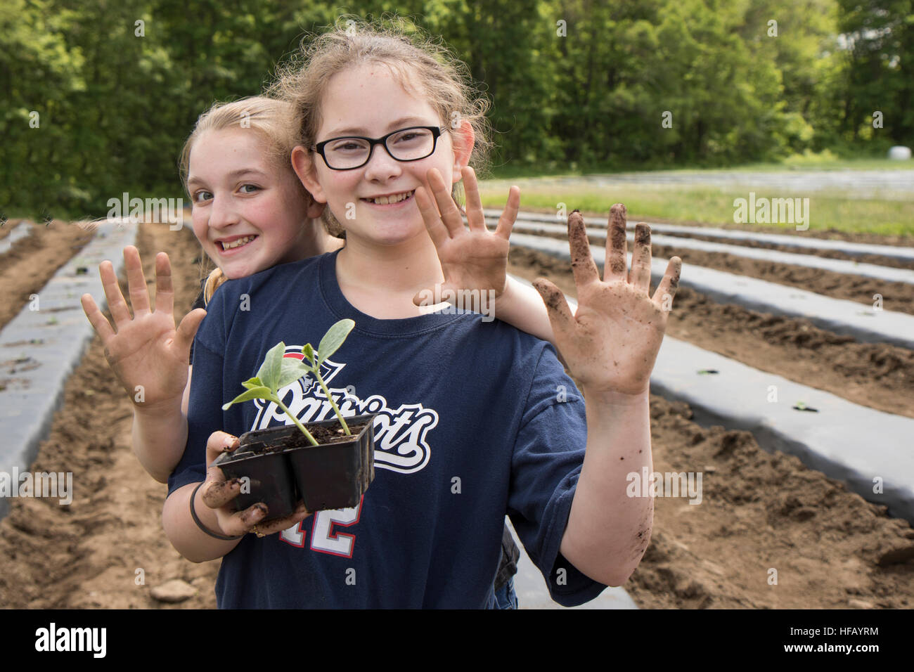 two girls with dirty hands from garden work Stock Photo