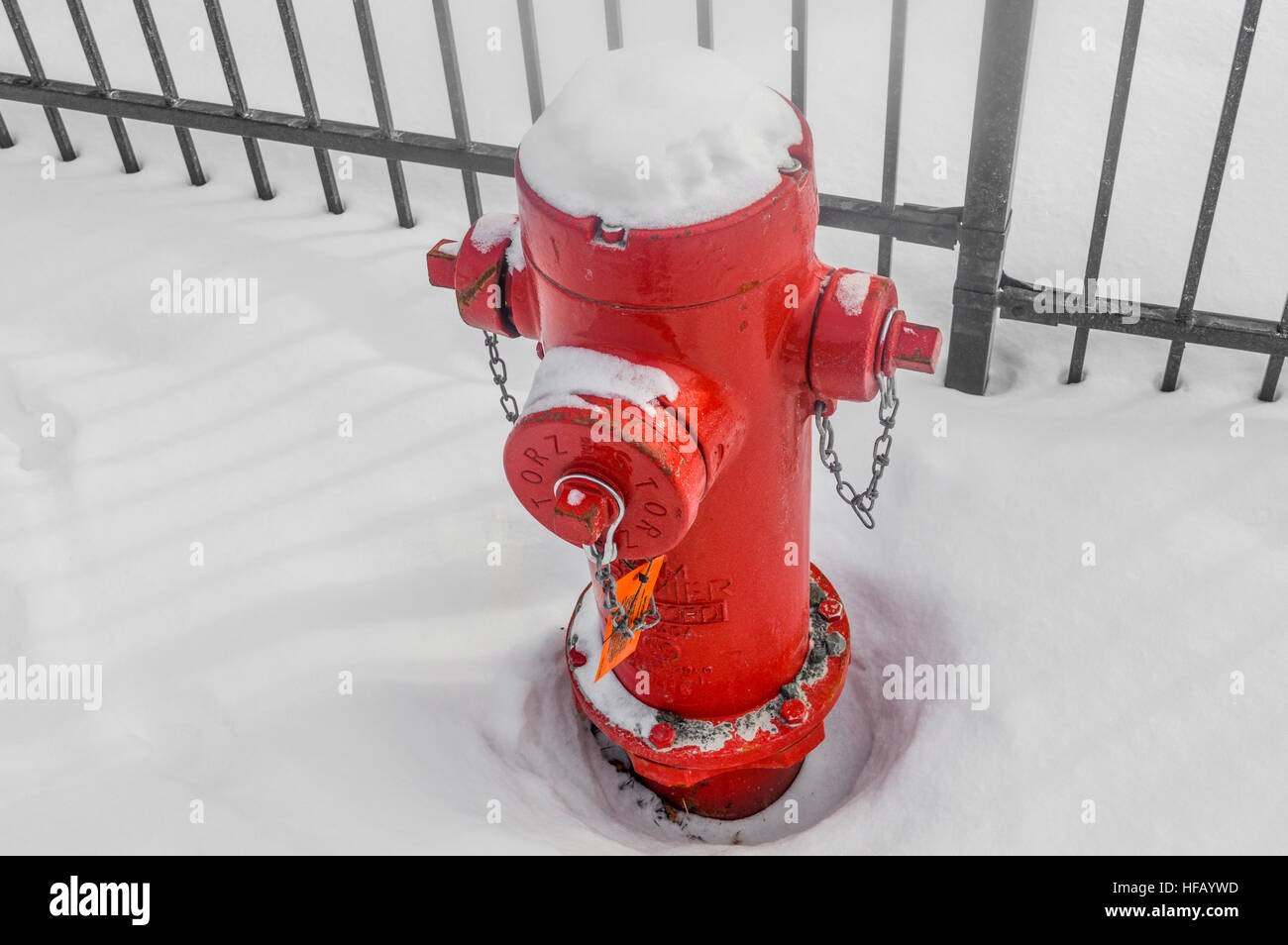 Montreal, Canada - December 29, 2016. Red fire hydrant sunk in the snow. Stock Photo