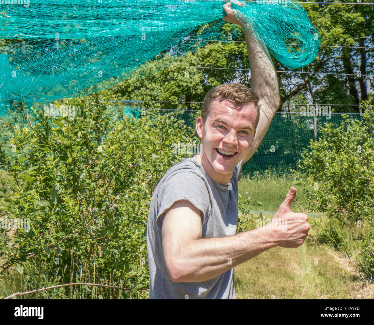 A very happy guy working in an orchard Stock Photo