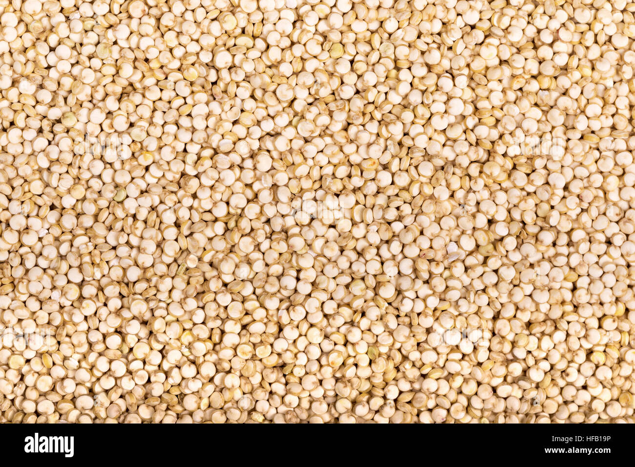 A background of white Chenopodium quinoa seeds, a superfood high in protein and fibre. Stock Photo