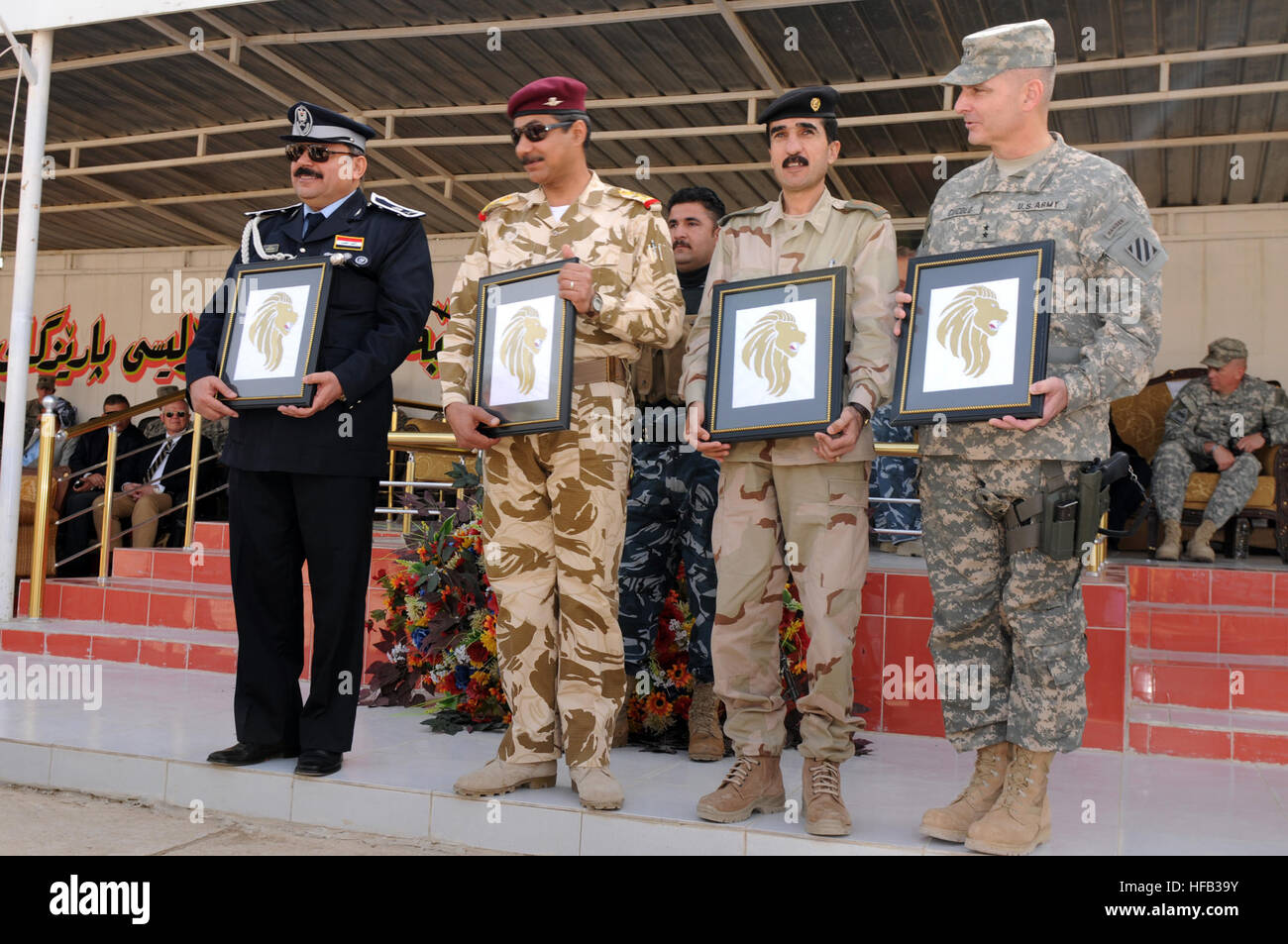 Maj. Gen. Jamal Taher Bakr, provincial director of police, Brig. Gen Abdul Amir Hassan, division deputy commander, Iraqi Army,  Brig. Gen. Shirko Fatih Schiwani, representative for the Kurdistan Regional Government, and Maj. Gen. Anthony A. Cucolo, III, commanding general, 3rd Infantry Division, present their Golden Lion plaques during the Combined Security Force Graduation Ceremony at the Kirkuk Training Center in Kirkuk, Iraq, Feb. 15. The CSF is a unit comprised of U.S., Kurdish and Iraqi personnel designed specifically to increase security during the election process. Combined Security For Stock Photo
