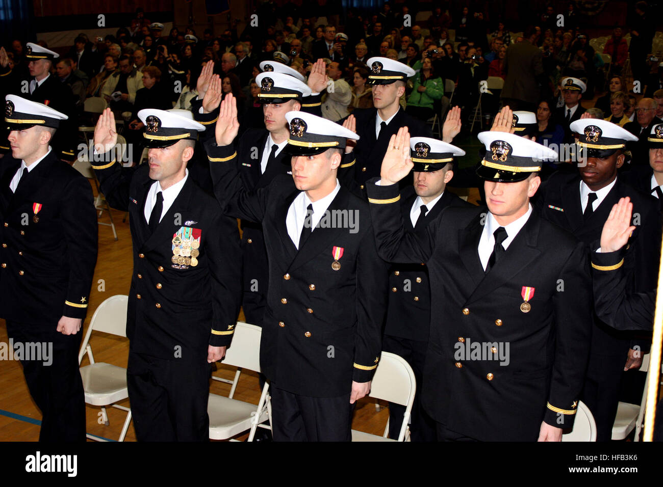 Officer candidates take the oath of office during a commissioning ceremony following graduation from Officer Candidate School at Naval Station Newport. (U.S. Navy photo by Gregg Kohlweiss) Commissioning ceremony 258125 Stock Photo