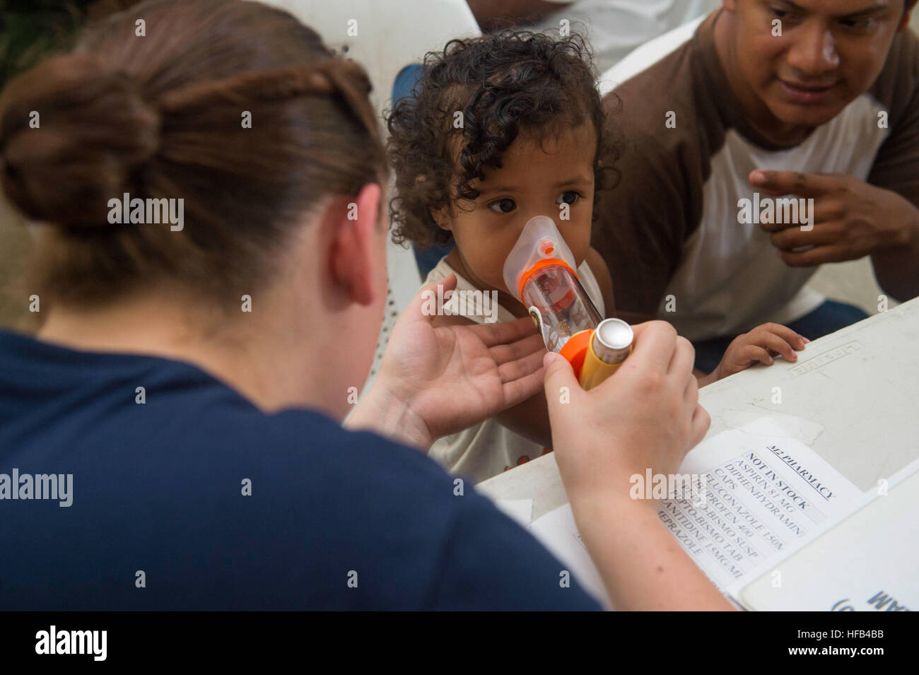 Navy Inhaler A Hospital Corpsman instructs a child on proper inhaler use at a ...