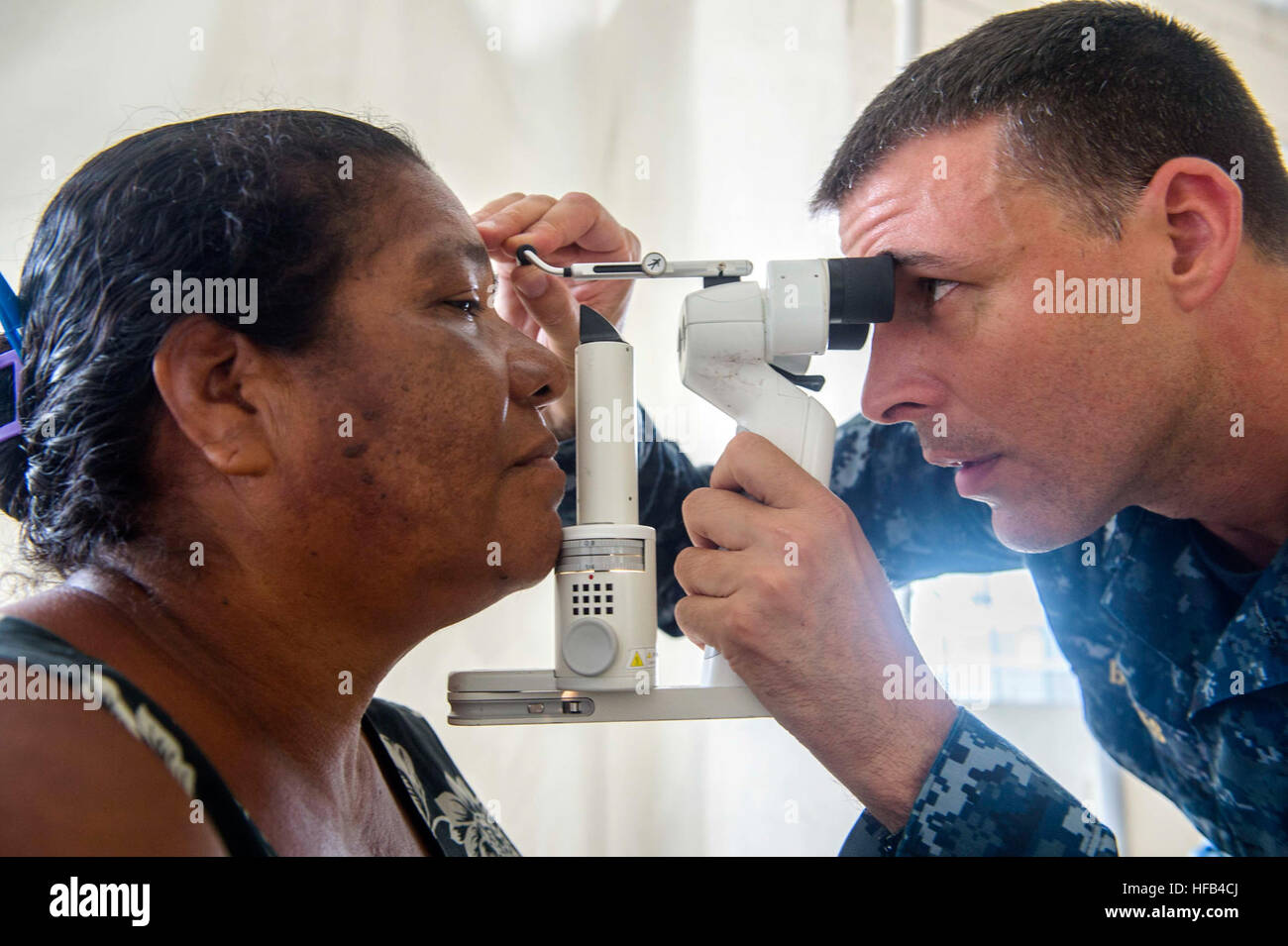 150521-N-XQ474-109 PUERTO CABEZAS, Nicaragua (May 21, 2015) Cmdr. Eric Barnes, a native of Virginia Beach, Va., and optometrist assigned to Naval Station Norfolk Branch Health Clinic, Va., performs an eye exam on a patient at a medical site established at the Instituto Politechnico Heroes y Martires during Continuing Promise 2015. Continuing Promise is a U.S. Southern Command-sponsored and U.S. Naval Forces Southern Command/U.S. 4th Fleet-conducted deployment to conduct civil-military operations including humanitarian-civil assistance, subject matter expert exchanges, medical, dental, veterina Stock Photo