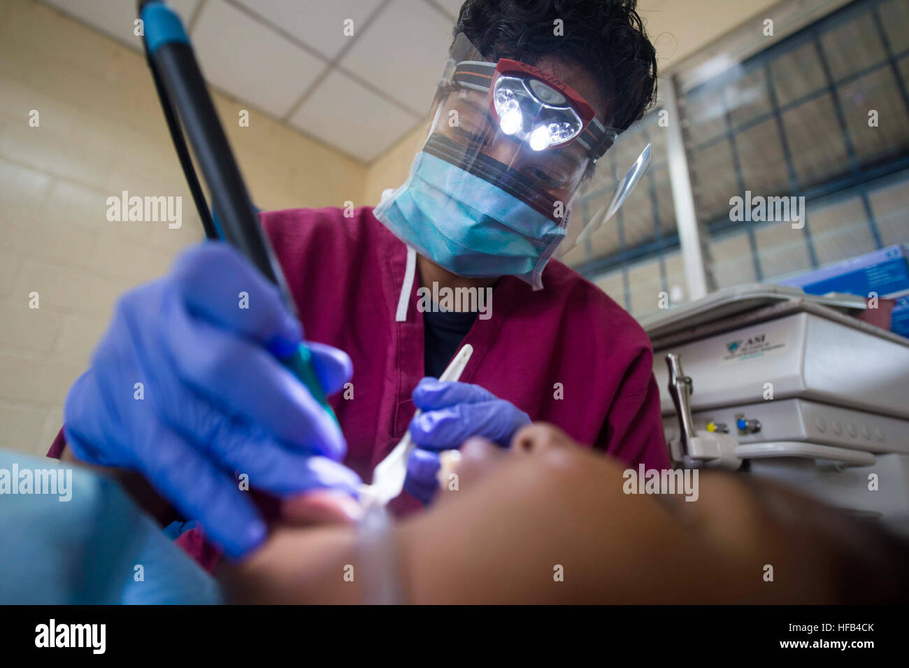 150521-N-XQ474-147 PUERTO CABEZAS, Nicaragua (May 21, 2015) Chief Hospital Corpsman Janae Smart, a native of Norfolk, Va., assigned to Naval Air Station Oceana Branch Health Clinic, Virginia Beach, Va., performs a dental cleaning on a patient at a medical site established at the Instituto Politechnico Heroes y Martires during Continuing Promise 2015. Continuing Promise is a U.S. Southern Command-sponsored and U.S. Naval Forces Southern Command/U.S. 4th Fleet-conducted deployment to conduct civil-military operations including humanitarian-civil assistance, subject matter expert exchanges, medic Stock Photo
