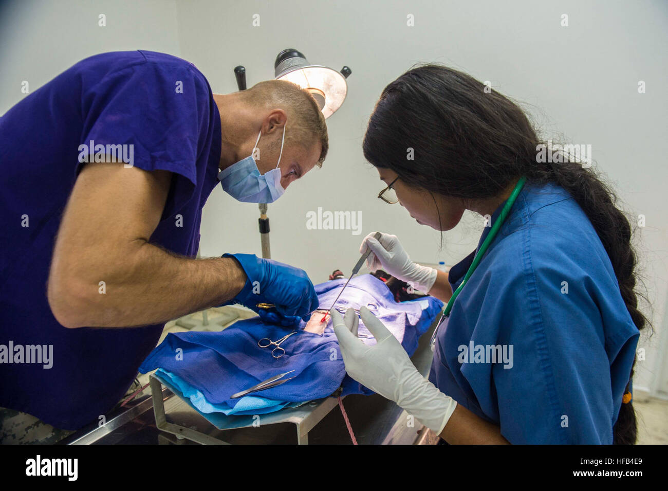 150820-N-YM856-110 SANTO DOMINGO, Dominican Republic (Aug. 20, 2015) Army Maj. Jeremiah Nelson, a veterinarian assigned to 85th Civil Affairs Brigade, Fort Hood, Texas and a Dominican veterinary technician perform surgery on a dog at a veterinary site established at Hospital Clinico Veterinario during Continuing Promise 2015.  Continuing Promise is a U.S. Southern Command-sponsored and U.S. Naval Forces Southern Command/U.S. 4th Fleet-conducted deployment to conduct civil-military operations including humanitarian-civil assistance, subject matter expert exchanges, medical, dental, veterinary a Stock Photo