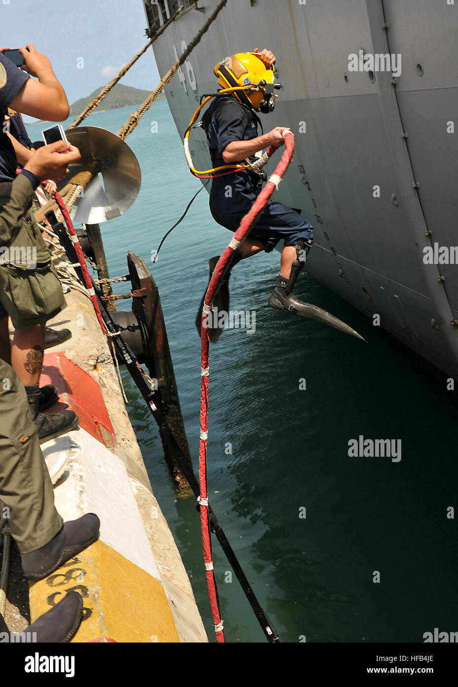 Petty Officer 2nd Class Brandon Zachry, Navy diver, leaps into the water next to the amphibious