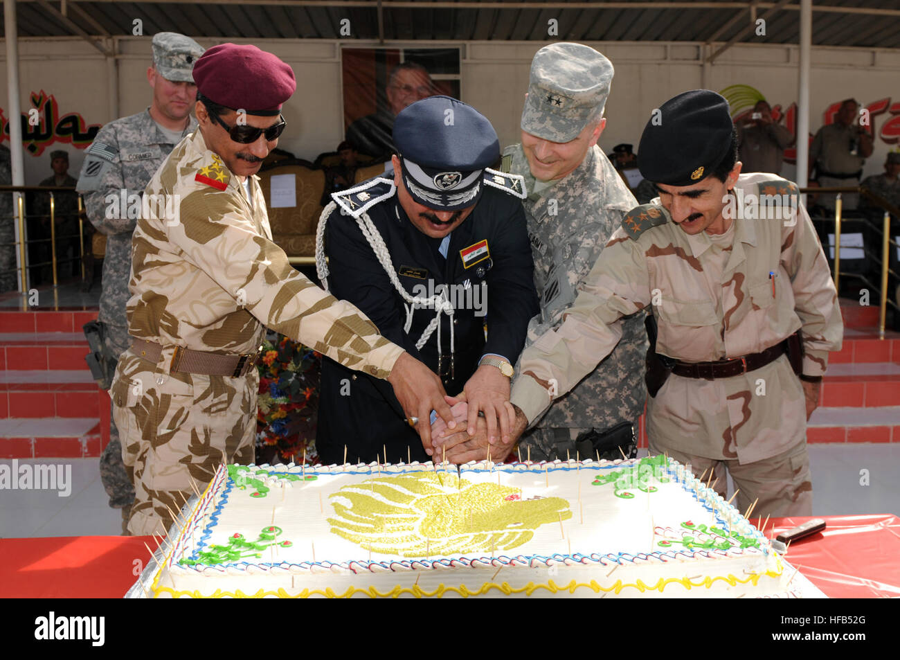 Brig. Gen Abdul Amir Hassan, division deputy commander, Iraqi Army, Maj. Gen. Jamal Taher Bakr, provincial director of police, Maj. Gen. Anthony A. Cucolo, III, commanding general, 3rd Infantry Division, and Brig. Gen. Shirko Fatih Schiwani, representative for the Kurdistan Regional Government, cut a cake during the Combined Security Force Graduation Ceremony at the Kirkuk Training Center in Kirkuk, Iraq, Feb. 15. The CSF is a unit comprised of U.S., Kurdish and Iraqi personnel designed specifically to increase security during the election process. CSF Graduates 252770 Stock Photo