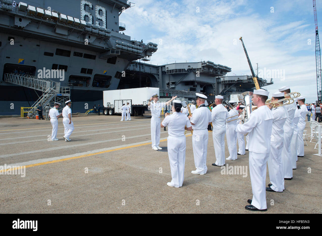 160601-N-XG464-042  NORFOLK, Va. (June 1, 2016) – U.S. Fleet Forces Band plays music in preparation for the departure of the aircraft carrier USS Dwight D. Eisenhower (CVN 69) and guided-missile destroyer USS Nitze (DDG 94). CVN 69 departs Naval Station Norfolk with the USS Dwight D. Eisenhower Carrier Strike Group (CSG). The ships are deploying in support of maritime security operations and theater security cooperation efforts in the U.S. 5th and 6th Fleet areas of operation as well as the Great Green Fleet initiative. While deployed, CSG ships and aircraft will employ operational procedures  Stock Photo