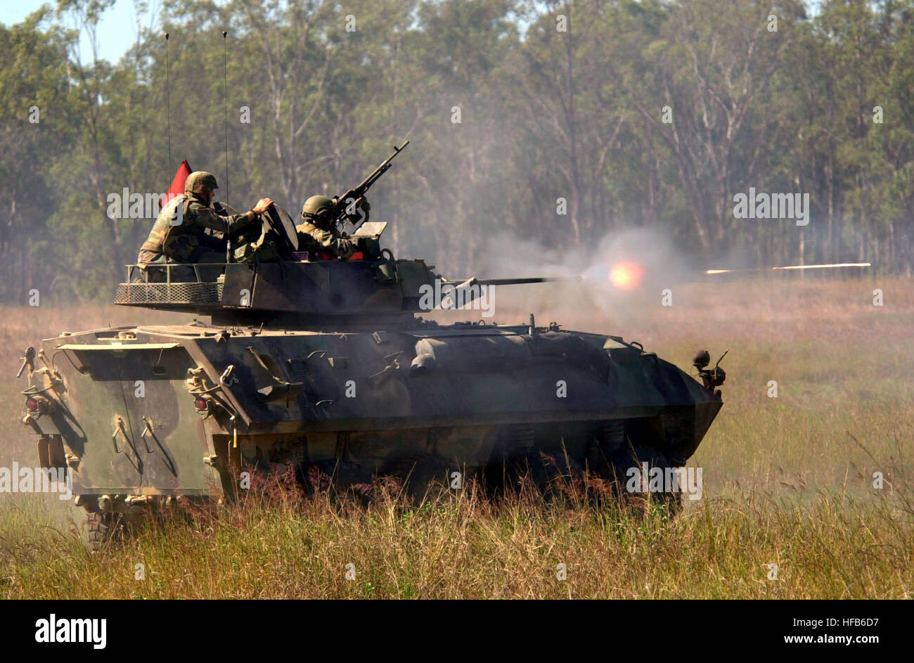 010525-N-9818S-005 Marines commence a live fire with a Light Armored Vehicle for Exercise Tandem Thrust 2001 at Schoalwater Bay Training Area, Queensland, Australia, on May 25, 2001.  Tandem Thrust is a combined military training exercise involving more than 18,000 U.S., Australian, and Canadian personnel who are training in crisis action planning and execution of contingency response operations.  These Marines are part of the 4th Light Armored Reconnaissance Battalion, deployed from Quantico, Va..  DoD photo by Petty Officer 3rd Class Jennifer A. Smith, U.S. Navy.  (Released) Defense.gov News Stock Photo
