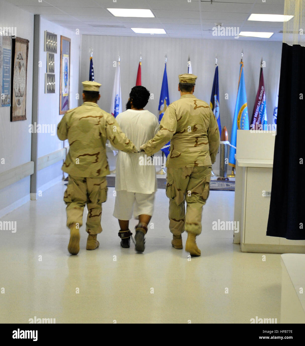A detainee is escorted to the detainee hospital for patient care by personnel from the Joint Medical Group, which provides medical care to detainees. Detainee care at Guantanamo Bay 336095 Stock Photo