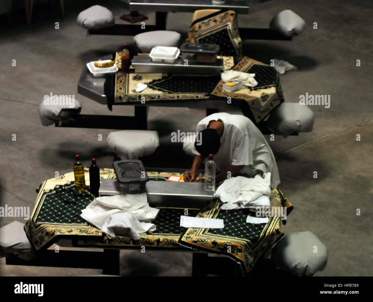 A detainee writes in the communal area of Camp Six at Joint Task Force Guantanamo, Oct. 29, 2010. Detainee Rec Time in Camp 6 338218 Stock Photo