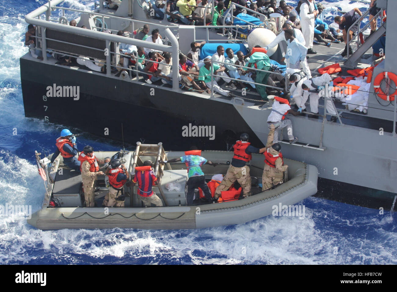 MEDITERRANEAN SEA (Oct. 17, 2013) Distressed persons are transferred from the amphibious transport dock ship USS San Antonio (LPD 17) to Armed Forces of Malta offshore patrol vessel P52. San Antonio provided food, water, medical attention, and temporary shelter to the rescued. San Antonio rescued 128 men adrift in an inflatable raft after responding to a call by the Maltese Government. (U.S. Navy photo/Released) 131017-N-ZZ999-009 Join the conversation http://www.navy.mil/viewGallery.asp http://www.facebook.com/USNavy http://www.twitter.com/USNavy http://navylive.dodlive.mil http://pinterest.c Stock Photo