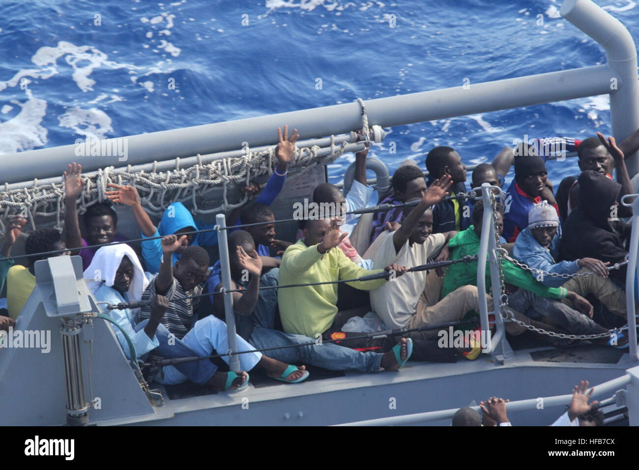 MEDITERRANEAN SEA (Oct. 17, 2013) Distressed persons wave after being transferred from the amphibious transport dock ship USS San Antonio (LPD 17) to Armed Forces of Malta offshore patrol vessel P52. San Antonio provided food, water, medical attention, and temporary shelter to the rescued. San Antonio rescued 128 men adrift in an inflatable raft after responding to a call by the Maltese Government. (U.S. Navy photo/Released) 131017-N-ZZ999-011 Join the conversation http://www.navy.mil/viewGallery.asp http://www.facebook.com/USNavy http://www.twitter.com/USNavy http://navylive.dodlive.mil http: Stock Photo