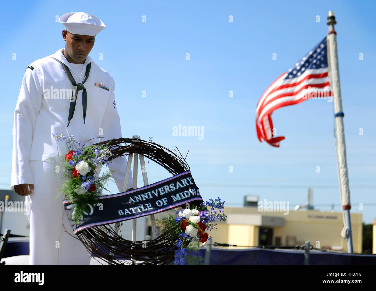U.S. Navy Seaman Andrew Fields lowers his head for the invocation