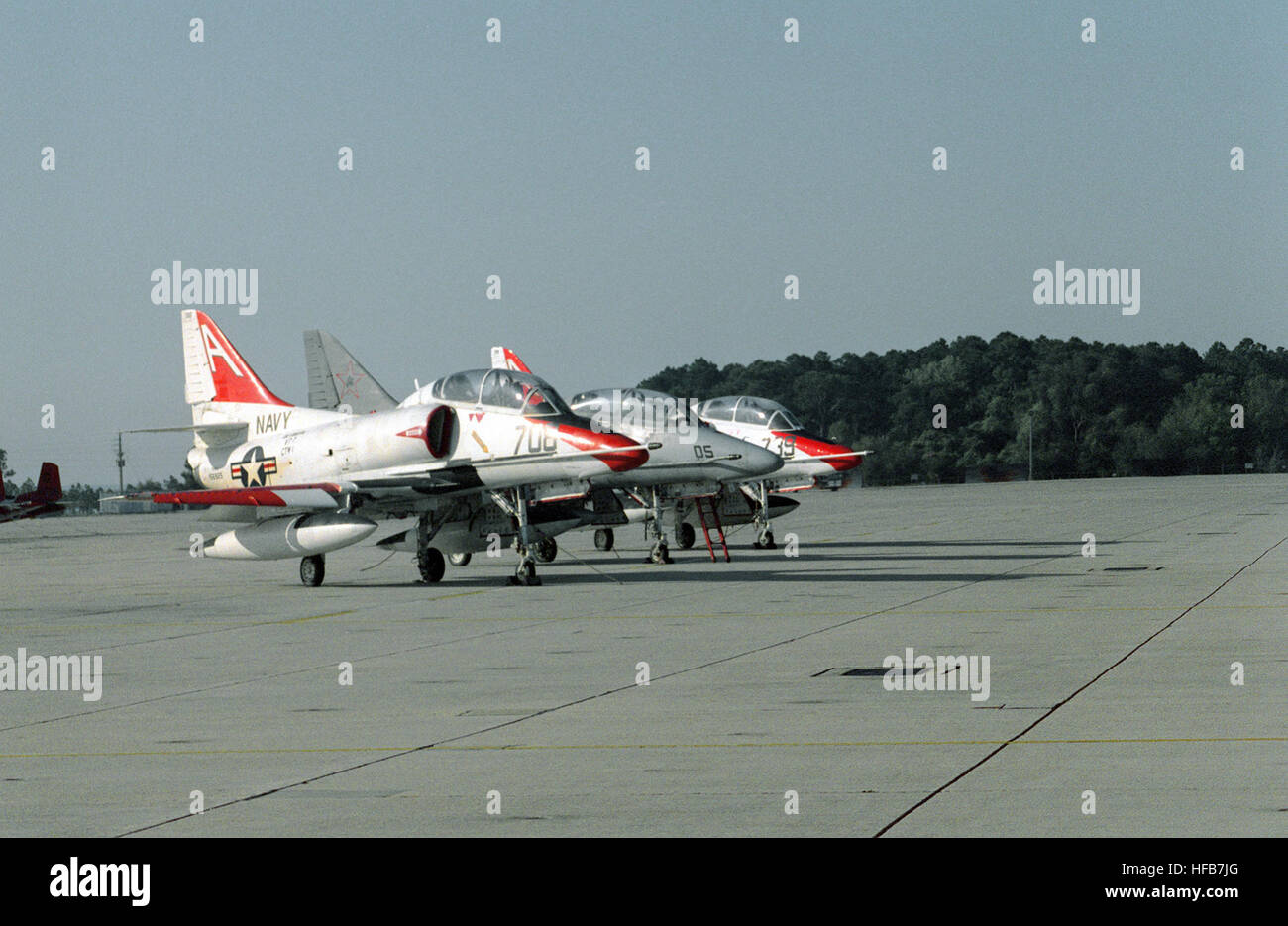 A right side view of two Training Squadron 7f (VT-7) TA-4J Skyhawk aircraft parked on either side of a TA-4F Skyhawk from an aggressor squadron. DN-SC-93-04555 Stock Photo