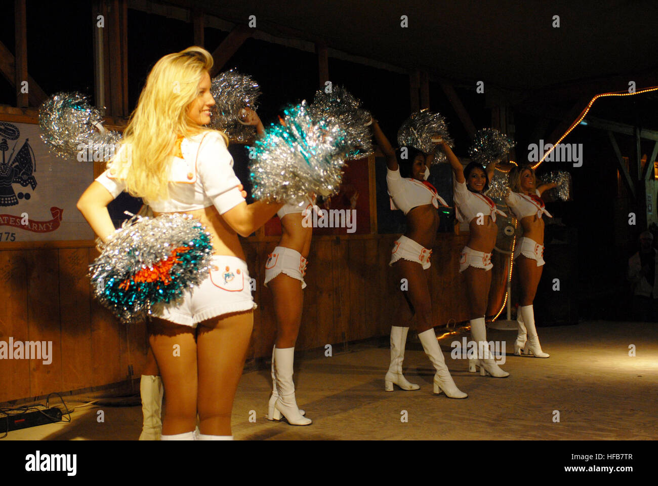 Miami Dolphins' cheerleaders entertained Soldiers, Sailors, Marines and Airmen on a tour of the area. They performed a few dance routines and signed autographs for the troops. Dolphins cheerleaders Djibouti 7 Stock Photo