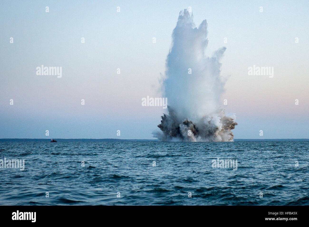 150525-N-RA981-223  BALTIC SEA (May 25, 2015) Members of a Latvian explosive ordnance disposal team use demolition charges to detonate a World War II-era German bottom-mine while conducting mine countermeasures operations in the Baltic Sea off the coast of Estonia during Exercise Open Spirit 2015. EODMU-8 is working in conjunction with explosive ordnance disposal teams from Estonia, Germany, Latvia, Lithuania, Poland and Sweden to dispose of unexploded ordnance originating from World War II. (U.S. Navy photo by Mass Communication Specialist 2nd Class Patrick A. Ratcliff/Released) Explosion of  Stock Photo