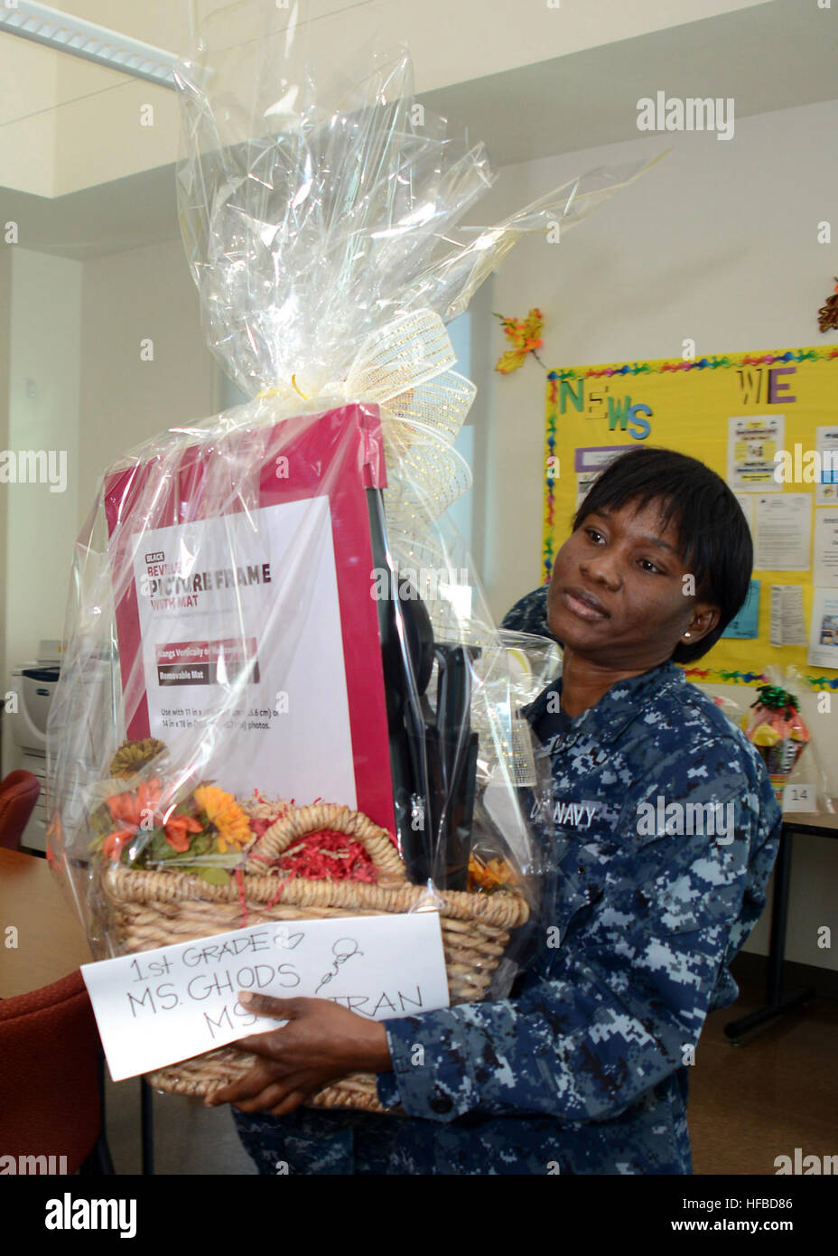 131030-N-BB534-270 SAN DIEGO (Oct. 30, 2013) Ship’s Serviceman Seaman Abidemi Omolewu carries a silent auction basket from the teacher’s lounge to the fall festival at Vista Del Mar Elementary School. Sailors assigned to amphibious transport dock ship USS Green Bay (LPD 20) volunteered to run the games at the school’s fall festival. Green Bay is conducting a regularly scheduled dry dock period at General Dynamics National Steel and Shipbuilding Company (NASSCO). (U.S. Navy photo by Mass Communication Specialist 1st Class Elizabeth Merriam/Released) Fall festival at Vista Del Mar Elementary Sch Stock Photo