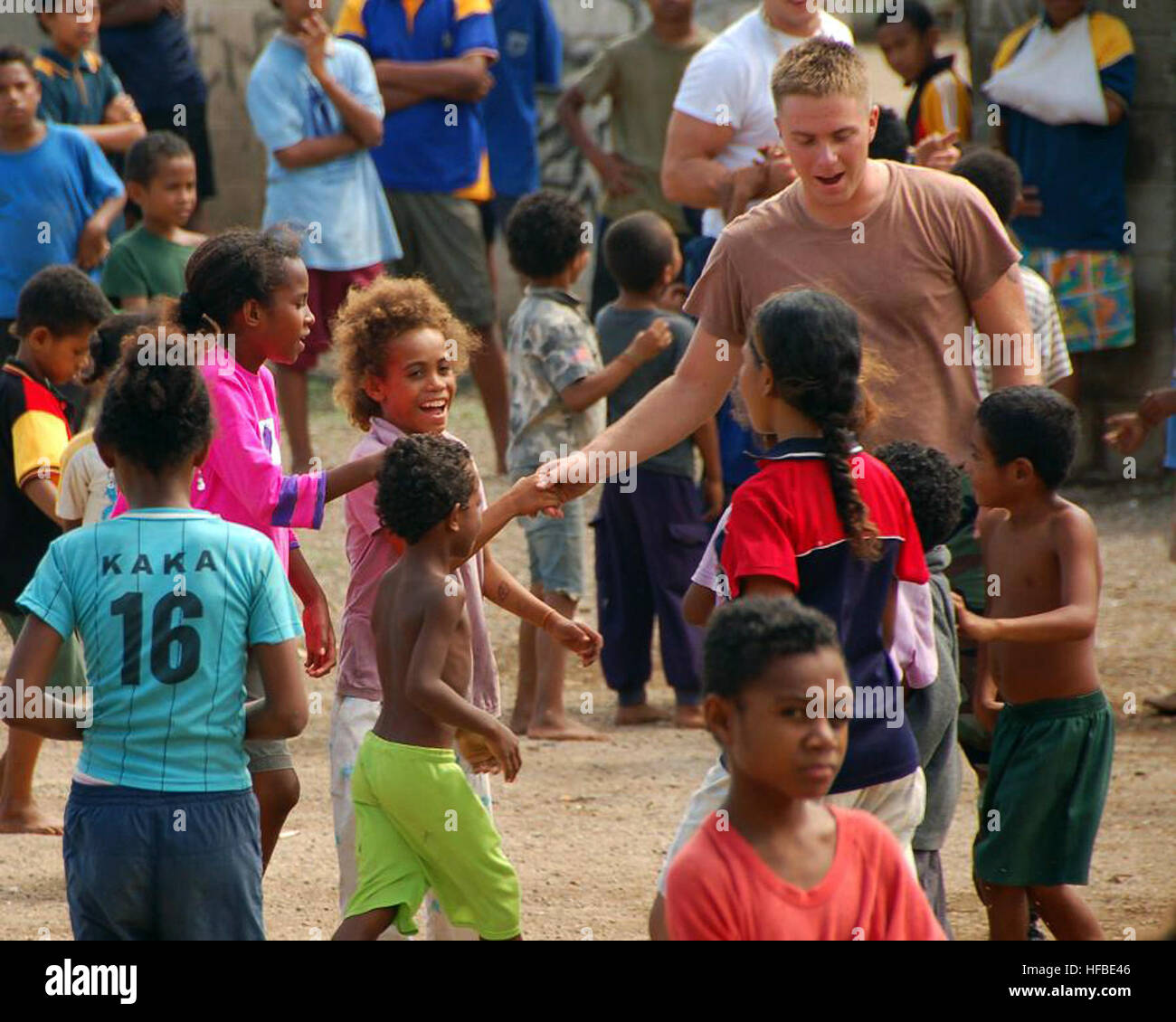 Petty Officer 3rd Class Travis Wright, from Jackson, Miss., assigned to Amphibious Construction Battalion 1, greets children in Pari Village, Papua New Guinea. Wright is assisting in the renovation of the village's main clinic. U.S. Navy Seabees, Royal Australian engineers from 1st Combat Engineer Regiment and members of the Indian army corps of engineers are providing humanitarian civic assistance to the people of Papua New Guinea as part of Pacific Partnership 2008. Fixing up a clinic in Papua New Guinea 108447 Stock Photo