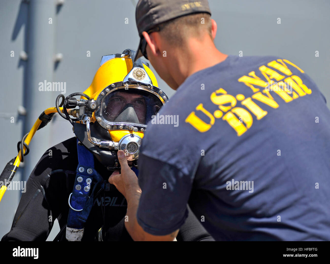 120710-N-ZS026-214 SAN DIEGO (July 10, 2012) Navy Diver 2nd Class Dustin Bigby, assigned to Southwest Regional Maintenance Center, conducts a pre-dive equipment check before performing underwater hull maintenance on the amphibious assault ship USS Boxer (LHD 4). Southwest Regional Maintenance Center is the largest shore based intermediate maintenance activity and the second largest ship repair facility in the Southwestern United States, providing intermediate level maintenance support to more than 100 surface ships and submarines of the U.S. Pacific Fleet and U.S. Coast Guard. (U.S. Navy photo Stock Photo