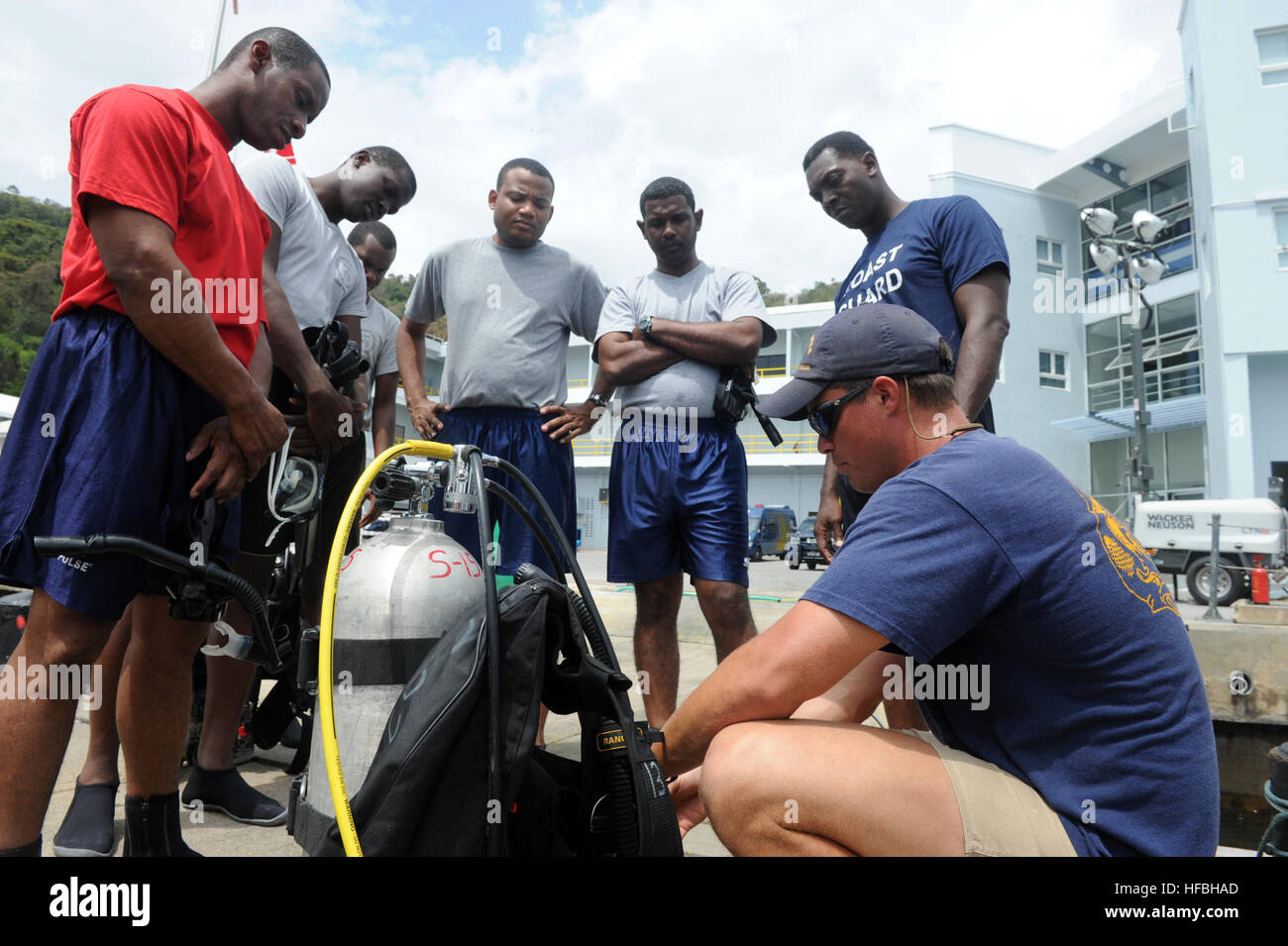 120322-N-BJ279-160  CHAGUARAMAS COAST GUARD BASE, Trinidad and Tobago (March 22, 2012) Chief Navy Diver Joshua Baker, assigned to Mobile Diving and Salvage Unit (MDSU) 2, Company 2-1, goes over the SCUBA rig with the Trinidad and Tobago divers. Company 2-1 is participating in Navy Dive Southern Partnership Station 2012, a multinational partnership engagement designed to increase interoperability and partner nation capacity through diving operations. (U.S. Navy photo by Mass Communication Specialist 2nd Class Kathleen A. Gorby/Released)  Join the conversation http://www.facebook.com/USNavy http Stock Photo