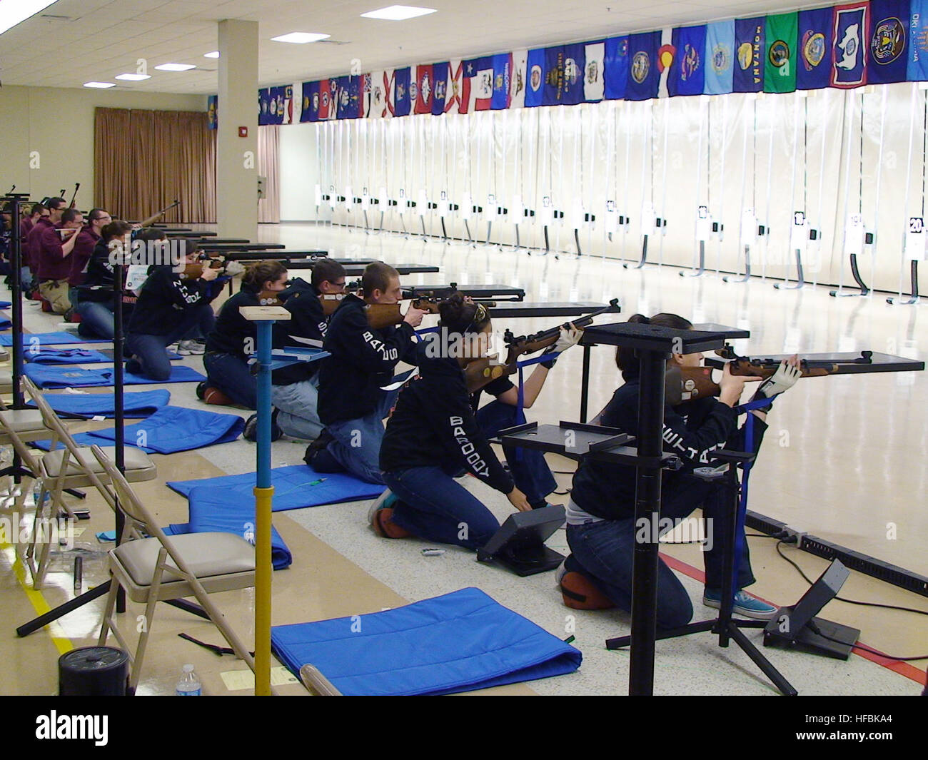 110212-N-FO977-327 ANNISTON, Ala. (Feb. 12, 2011) Navy Junior Reserve Officers Training Corps (NJROTC) sporter division cadets line up in the kneeling firing position as they prepare to fire their first shots during the 2011 NJROTC Air Rifle Championship in Anniston, Ala. Approximately 200 NJROTC cadets from 51 high schools across the United States participated in the competition. (U.S. Navy photo by Mike Miller/Released)  - Official U.S. Navy Imagery - NJROTC cadets take part in air rifle competition. Stock Photo