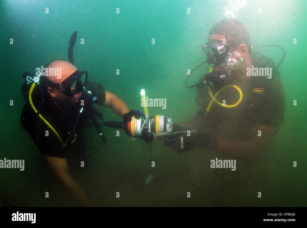 110728-N-XD935-195 PORT ROYAL, Jamaica, (July 28, 2011) Royal Bahamas Defense Force divers, Able Body Seaman Raynaldo Farquharson, left, and Able Body Seaman Omar Albury find an inert training mine on the sea floor utilizing a circle search line during joint diving search operations with Mobile Diving and Salvage Unit (MDSU) 2. MDSU-2 is participating in Navy Diver-Southern Partnership Station, a multinational partnership engagement designed to increase interoperability and partner nation capacity through diving operations. (U.S. Navy photo by Mass Communication Specialist 1st Class Jayme Past Stock Photo
