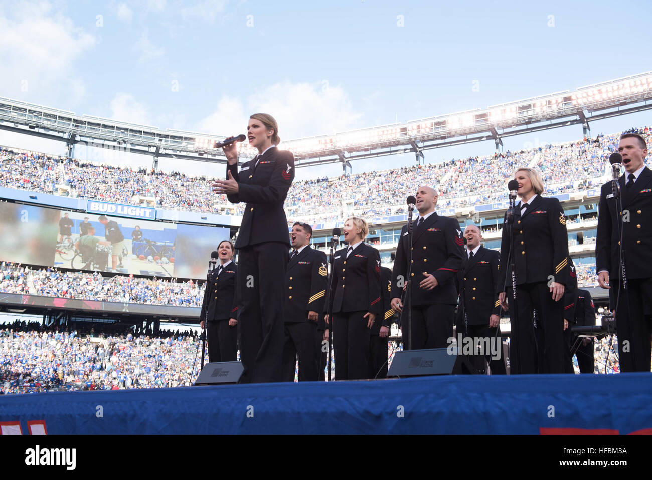 161106-N-HG258-069 East Rutherford, N.J. (November 6, 2016) Alto vocalist Petty Officer 1st Class Chelsi Ervien sings 'Fight Song' during a halftime show by the U.S. Navy Band at a National Football game between the New York Giants and Philadelphia Eagles. Members of the U.S. Navy Band Sea Chanters chorus and Cruisers contemporary music ensemble performed on the field at MetLife Staduim during a halftime show supporting the NFL's 'Salute to Service' game between the New York Giants and the Philadelphia Eagles. (U.S. Navy phot by SCPO Stephen Hassay/released) 161106-N-HG258-069 161106-N-HG258-0 Stock Photo