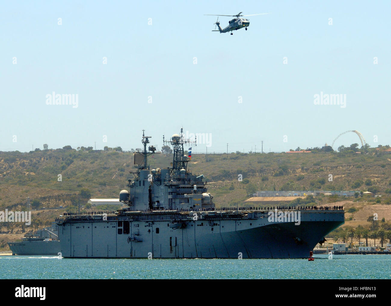 Sailors aboard USS Peleliu (LHA 5) man the rails in San Diego to honor ...