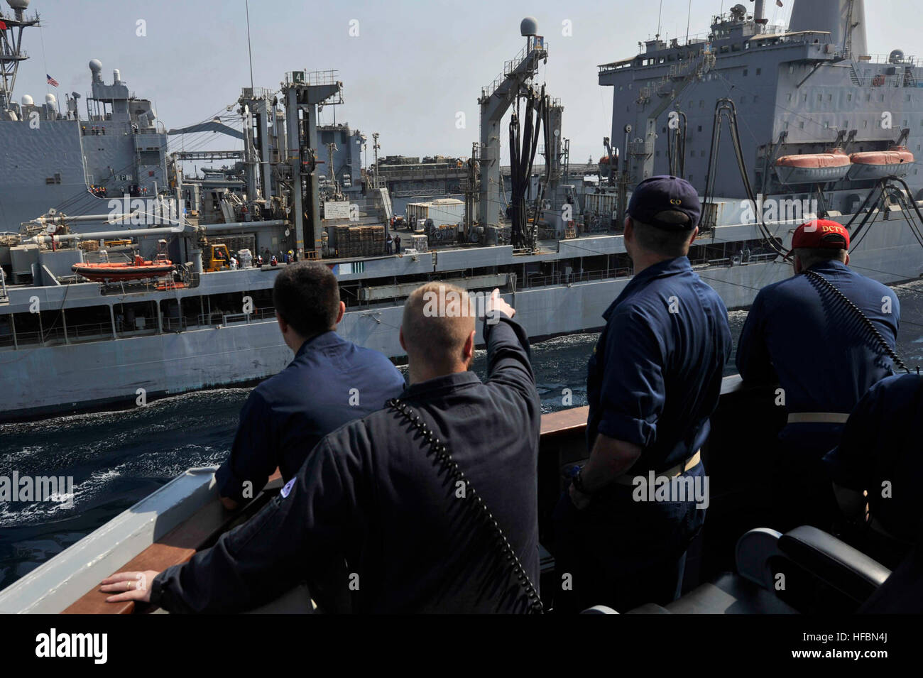 U.S. 5TH FLEET AREA OF RESPONSIBILITY (Oct. 7, 2012) Sailors aboard the guided-missile destroyer USS Jason Dunham (DDG 109) observe a replenishment at sea with the Military Sealift Command fleet replenishment oiler USNS Laramie (T-AO-203). Jason Dunham is deployed to the U.S. 5th Fleet area of responsibility conducting maritime security operations, theater security cooperation efforts and support missions for Operation Enduring Freedom. The U.S. Navy is constantly deployed to preserve peace, protect commerce, and deter aggression through forward presence. Join the conversation on social media  Stock Photo