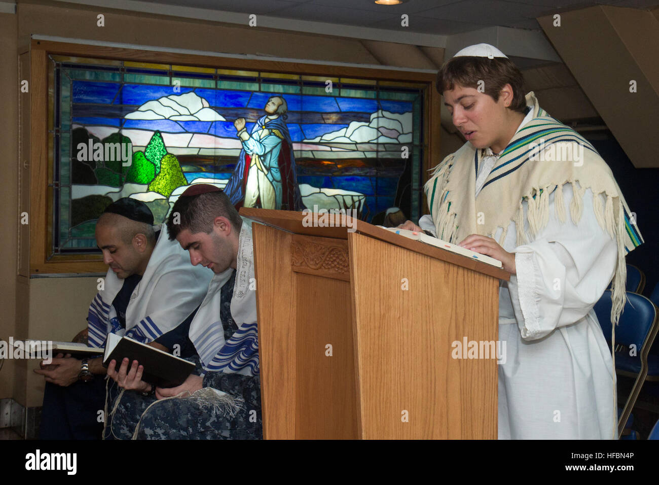 PACIFIC OCEAN (Sept. 25, 2012) Lt. j.g. Yonina Creditor, from Richmond, Va., a Jewish chaplain embarked aboard the aircraft carrier USS George Washington (CVN 73), leads Sailors in prayer during a Yom Kippur service in the ship’s chapel. George Washington and its embarked air wing, Carrier Air Wing (CVW) 5, provide a combat-ready force that protects and defends the collective maritime interest of the U.S. and its allies and partners in the Asia-Pacific region. (U.S. Navy photo by Mass Communication Specialist 3rd Class William Pittman/Released) 120925-N-SF704-119 Join the conversation http://w Stock Photo