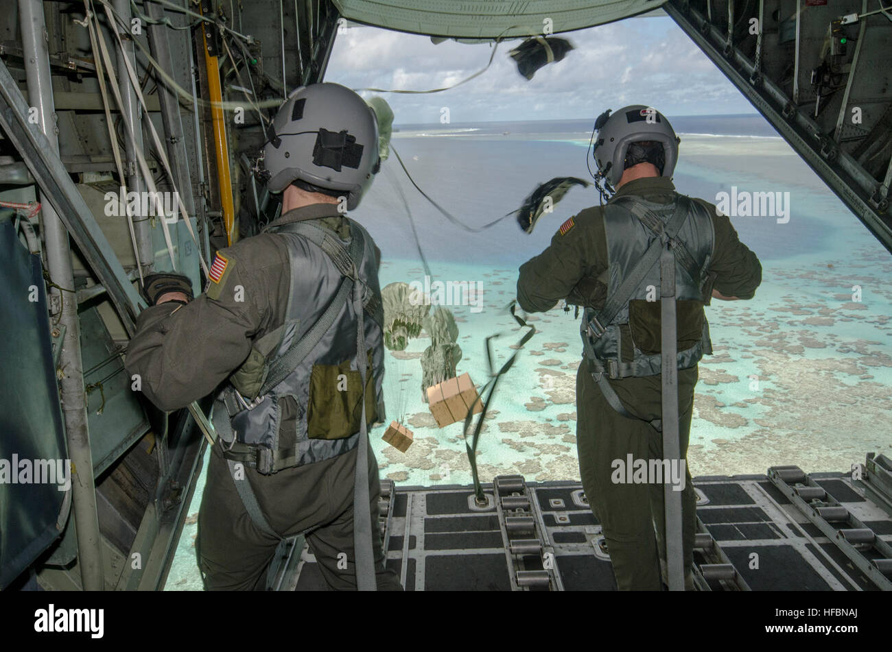161211-N-YM720-059  FEDERATED STATES OF MICRONESIA (Dec. 12, 2016) – Loadmasters attached to the 36th Airlift Squadron, Yokota Air Base, Japan, drop care packages out of a C-130H Hercules to a Micronesian island during Operation Christmas Drop Dec. 11.  Operation Christmas Drop is an international humanitarian operation that provides critical supplies to 56 islands through the Commonwealth of the Northern Marianas, Federated States of Micronesia and Republic of Palau, impacting about 20,000 people. (U.S. Navy photo by Petty Officer 2nd Class Allen Michael McNair/Released) 161211-N-YM720-059 16 Stock Photo