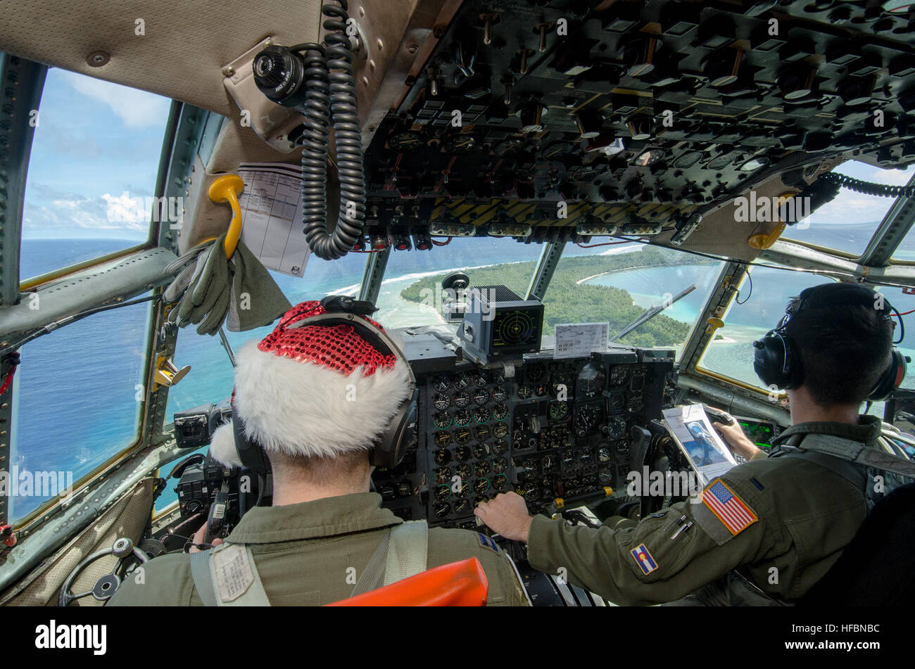 161211-N-YM720-116  FEDERATED STATES OF MICRONESIA (Dec. 12, 2016) – Air Force Capt. Jody Robertson and First Lt. Chad Moore, attached to 36th Airlift Squadron, Yokota Air Base, Japan, fly a C-130H Hercules over Ifalik, a small Micronesian island, during Operation Christmas Drop Dec. 11.  Operation Christmas Drop is an international humanitarian operation that provides critical supplies to 56 islands through the Commonwealth of the Northern Marianas, Federated States of Micronesia and Republic of Palau, impacting about 20,000 people. (U.S. Navy photo by Petty Officer 2nd Class Allen Michael Mc Stock Photo