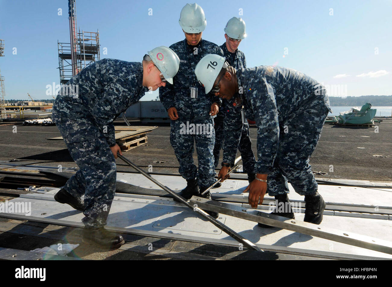 Retainers Ship Loading Personnel aboard the aircraft carrier USS Ronald Reagan (CVN 76) remove ...
