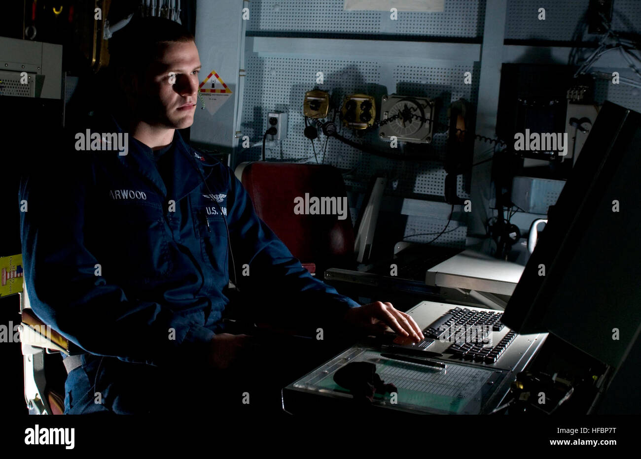 110220-N-7488A-020 ARABIAN SEA (Feb. 20, 2011) Air Traffic Controller 2nd Class Adam Arwood checks the aircraft landing schedule in air operations aboard the Nimitz-class aircraft carrier USS Carl Vinson (CVN 70). The Carl Vinson Carrier Strike Group is deployed supporting maritime security operations and theater security cooperation efforts in the U.S. 5th Fleet area of responsibility. (U.S. Navy by Mass Communication Specialist Seaman Rosa A. Arzola/Released)  - Official U.S. Navy Imagery - Sailor checks the aircraft landing schedule aboard USS Carl Vinson. Stock Photo