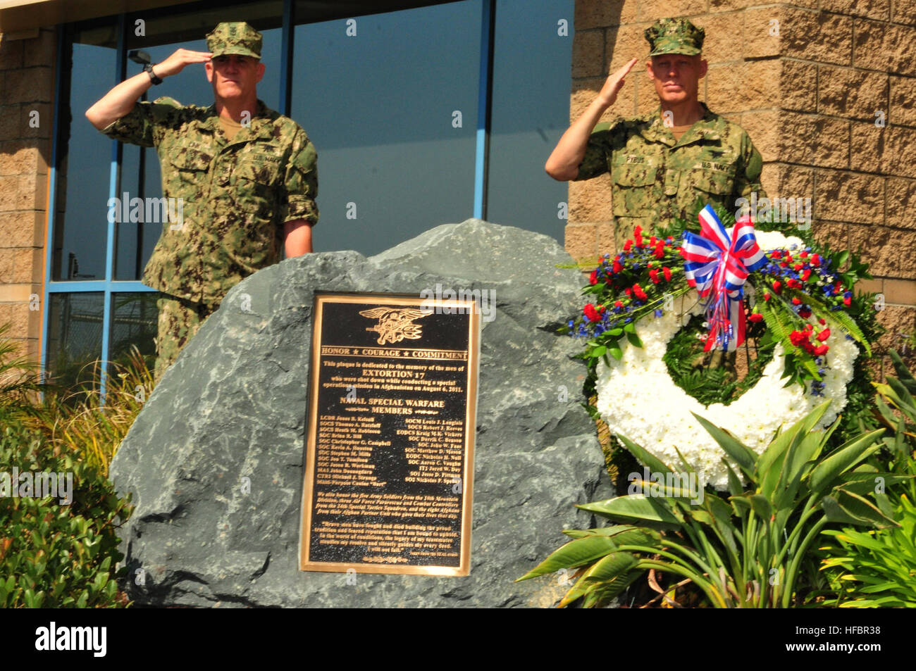 120806-N-CG160-082 CORONADO, Calif. (Aug. 6, 2012) Rear Adm. Sean Pybus, right, commander of Naval Special Warfare Command, right, and Force Master Chief (SEAL) Stephen Link salute as “Taps” is played during a memorial dedication ceremony at Naval Special Warfare Command in honor of the one-year anniversary of the Extortion 17 helicopter crash. The crash claimed the lives of 38 personnel, including 22 special operations forces in Afghanistan on Aug. 6, 2011. (U.S. Navy photo by Mass Communication Specialist 3rd Class Geneva G. Brier/Released)  - Official U.S. Navy Imagery - SEALs honor fallen  Stock Photo