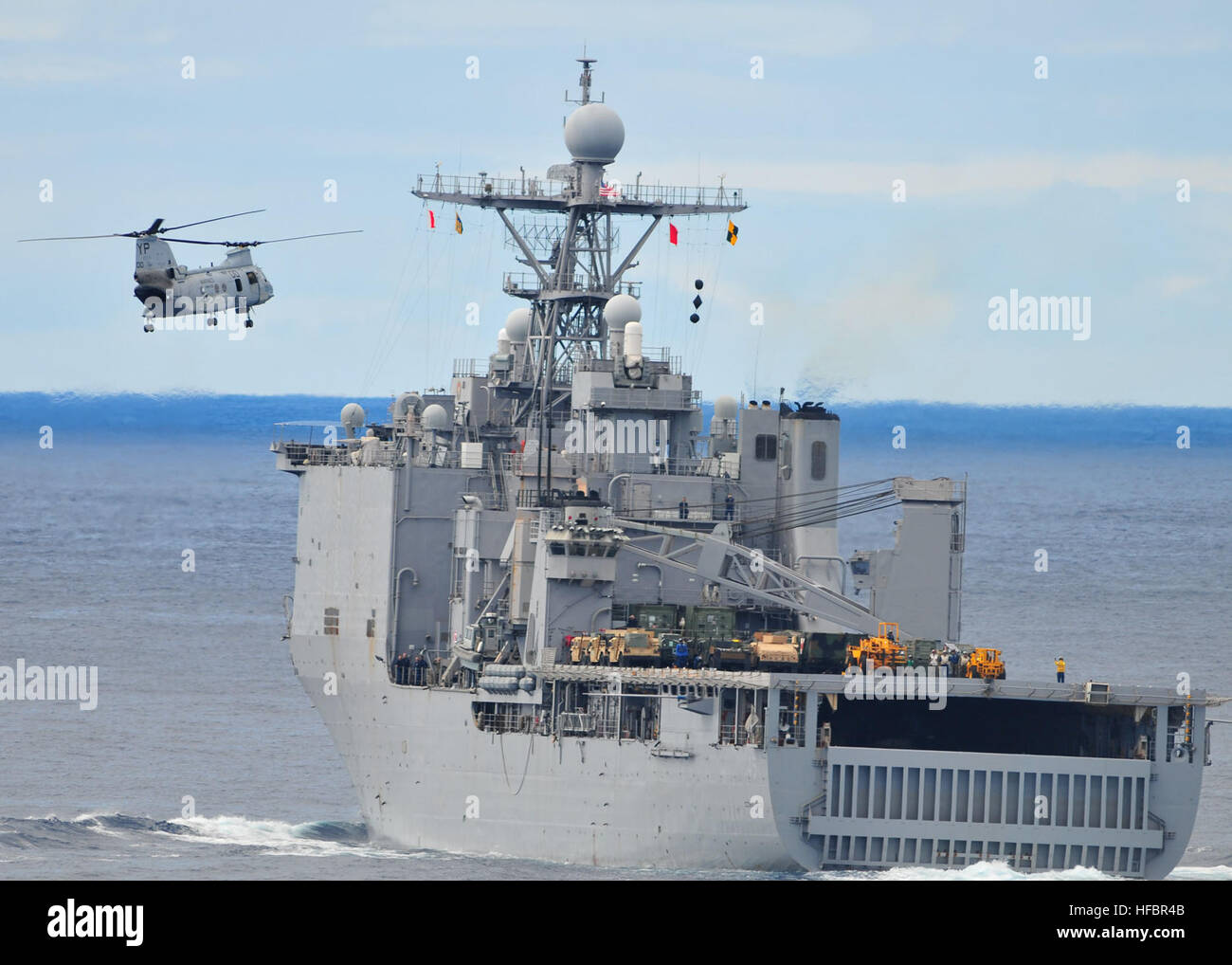 110224-N-ZS026-244 PACIFIC OCEAN (Feb. 24, 2011) A CH-46 Sea Knight helicopter assigned to the Evil Eyes of Marine Medium Squadron (HMM) 163 prepares to land aboard the amphibious dock landing ship USS Comstock (LSD 45) during a vertical replenishment. Comstock and Combat Logistics Battalion (CLB) 13 are part of the Boxer Amphibious Ready Group underway on a scheduled deployment to the western Pacific region. (U.S. Navy photo by Mass Communication Specialist 3rd Class Trevor Welsh/Released)  - Official U.S. Navy Imagery - Sea Knight helicopter prepares to land aboard USS Comstock. Stock Photo