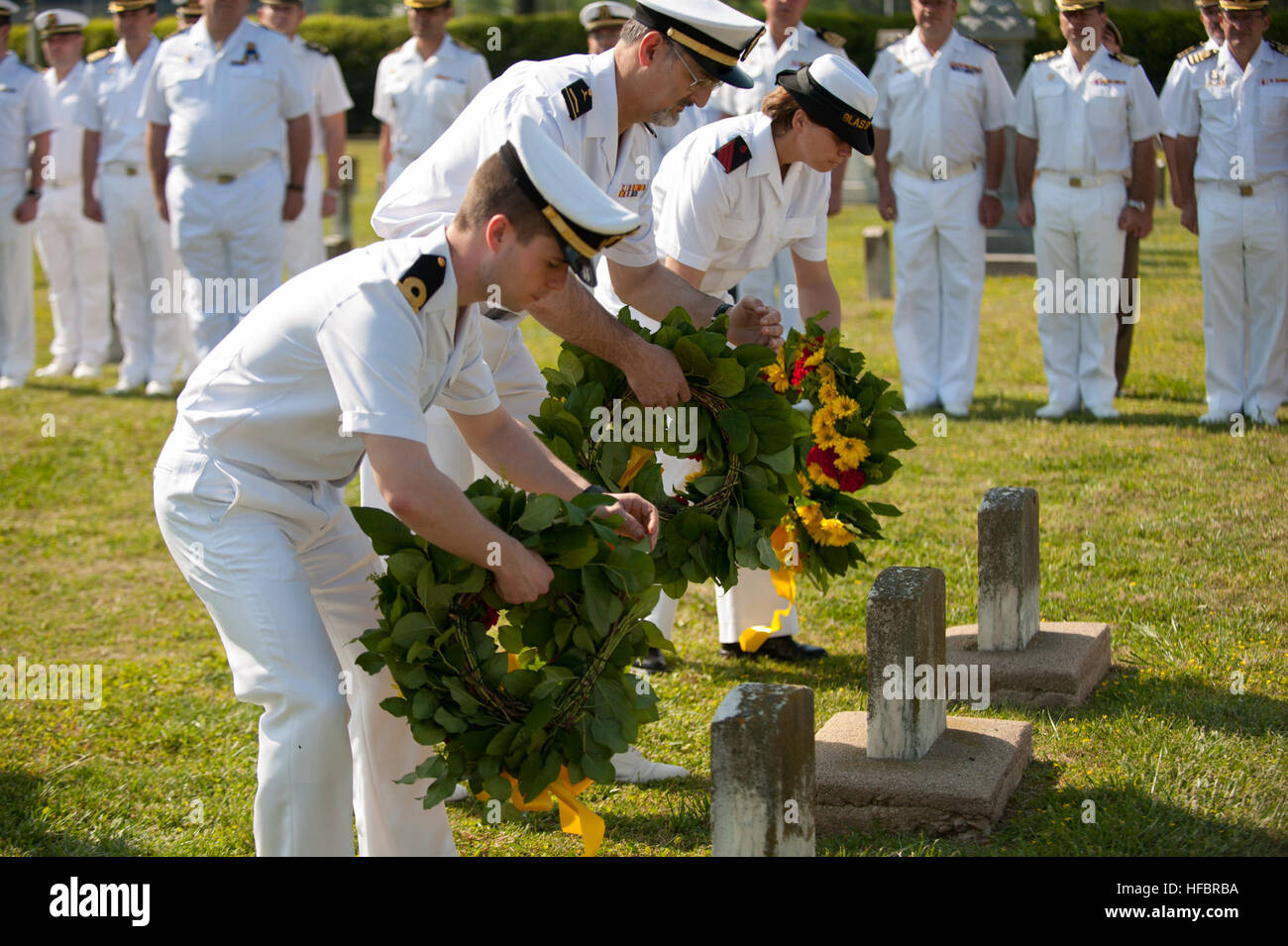 PORTSMOUTH, Va. (April 17, 2012) Spanish navy sailors lay wreaths during a ceremony at Captain Ted Conaway Memorial Naval Cemetery. The wreath laying was in remembrance of three Spanish prisoners of war who died in Portsmouth Naval Hospital during the Spanish-American War. (U.S. Navy photo by Mass Communication Specialist 2nd Class William Jamieson/Released) 120417-N-OV802-058 Join the conversation http://www.facebook.com/USNavy http://www.twitter.com/USNavy http://navylive.dodlive.mil  - Official U.S. Navy Imagery - Spanish navy sailors lay wreaths. Stock Photo